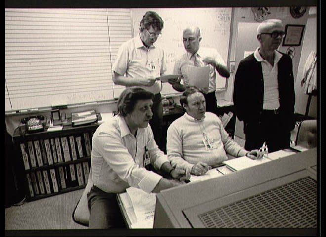 Mission Evaluation room team discuss the STS 51-L accident at JSC's engineering office facility. Seated left to right are Charles Walsh and David Camp. Standing left to right are Larry Meyers, James Mistrot and Travis Libby (011); (l.-r.) Walsh, Camp and Libby seated at table looking over paperwork (012); l.-r.) Walsh, Meyers, Camp, and Libby discuss 51-L (013); Wide angle view of conference room with (l.-r.) Meyers, Walsh, Camp, Libby and Walter Scott discussing STS 51-L accident (014). (NASA)