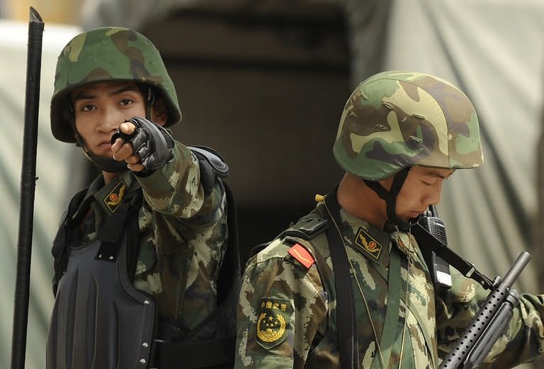 A Chinese paramilitary policeman points at the camera in Urumqi, Xinjiang province in 2010. Chinese President Xi Jinping has called for stability in the ethnically-divided region of Xinjiang after clashes this week killed 21 people, state media reported on Friday