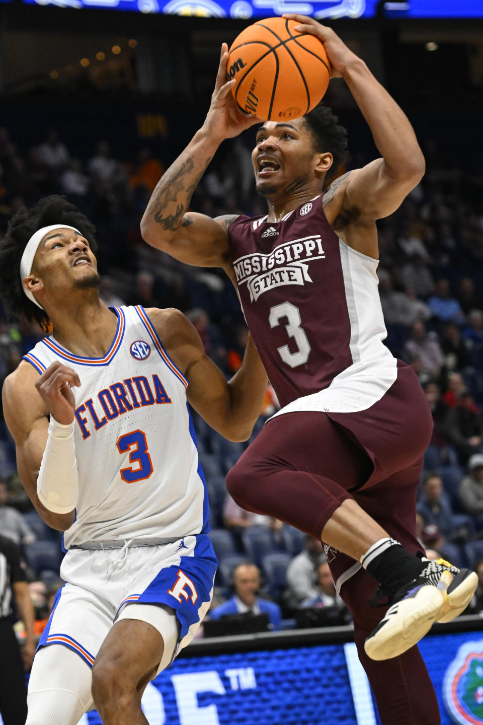 Mississippi State guard Shakeel Moore (3) goes up to shoot as Florida forward Alex Fudge (3) defends during the first half of an NCAA college basketball game in the second round of the Southeastern Conference Tournament, Thursday, March 9, 2023, in Nashville, Tenn.(AP Photo/John Amis)