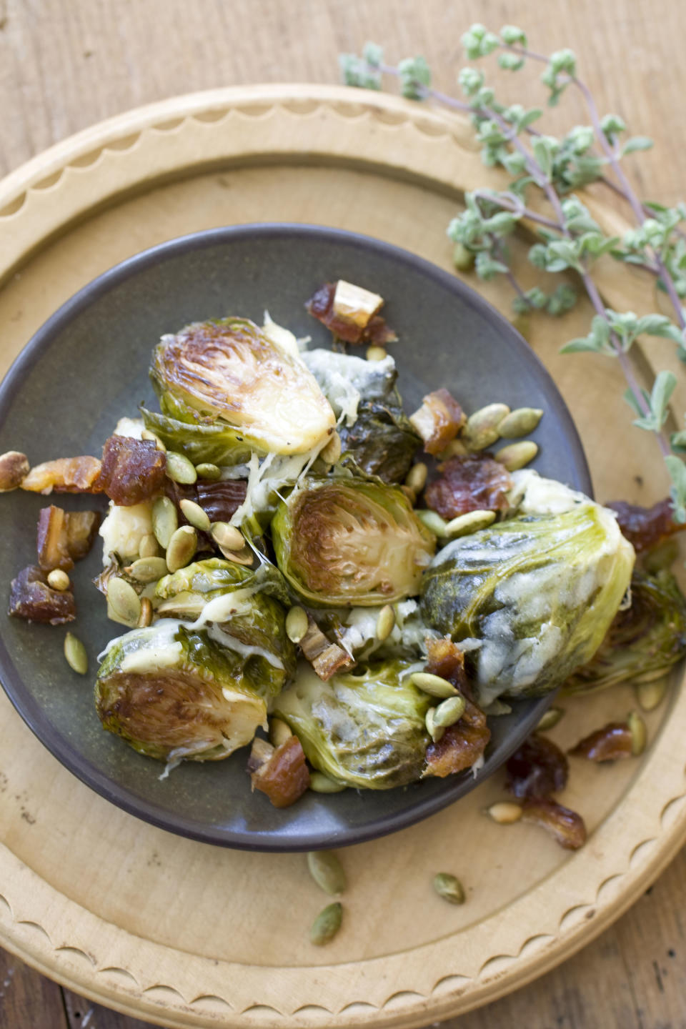 This Oct. 14, 2013 photo shows Gruyere roasted brussels sprouts with pepitas and dates in Concord, N.H. (AP Photo/Matthew Mead)