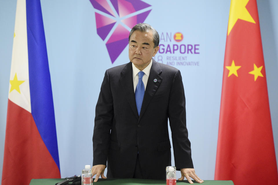 FILE - In this Thursday, Aug. 2, 2018, file photo, China's Foreign Minister Wang Yi pauses before a bilateral meeting with Philippines' Foreign Affairs Secretary Alan Cayetano on the sidelines of the 51st ASEAN Foreign Ministers Meeting in Singapore. Recent developments in the South China Sea leave China pitted against smaller neighbors in disputes over territorial rights in waters crucial for global commerce and rich in fish and potential oil and gas reserves. (AP Photo/Joseph Nair, File)
