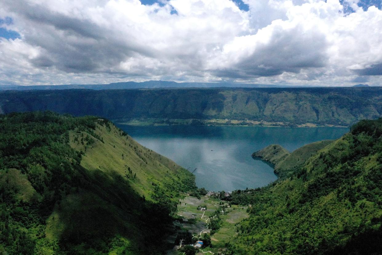 <p>Indonesia’s Lake Toba was formed by a gigantic volcanic eruption some 70,000 years ago</p> (GOH CHAI HIN/AFP via Getty Images)