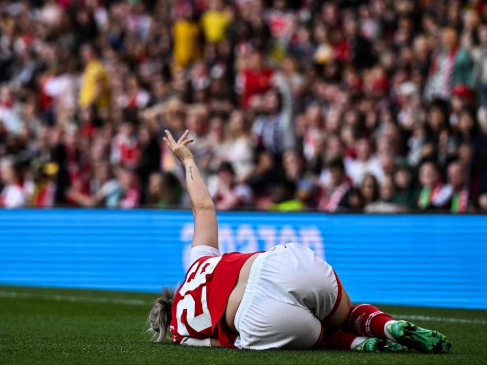 Arsenal's Laura Wienroither signals for help after suffering an ACL injury during a game on Monday. (AFP via Getty Images - image credit)