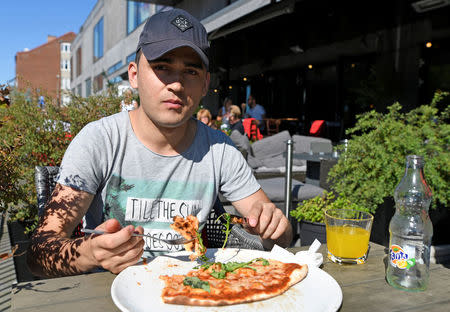 Afghan migrant Mohsen Naghawi eats in a restaurant in Karlshamn, Sweden, September 10, 2016. REUTERS/Fabian Bimmer