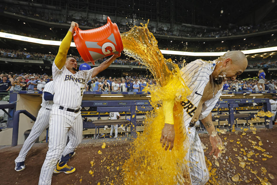 Milwaukee Brewers' Willy Adames, left, douses Blake Perkins, right, after Perkins hit a winning single against the Pittsburgh Pirates during the 10th inning of a baseball game Saturday, Aug 5, 2023, in Milwaukee. (AP Photo/Jeffrey Phelps)