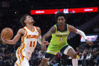 Minnesota Timberwolves forward Jaden McDaniels (3) fouls Atlanta Hawks guard Trae Young (11) during the first half of an NBA basketball game Wednesday, Jan. 19, 2022, in Atlanta. (AP Photo/Hakim Wright Sr.)