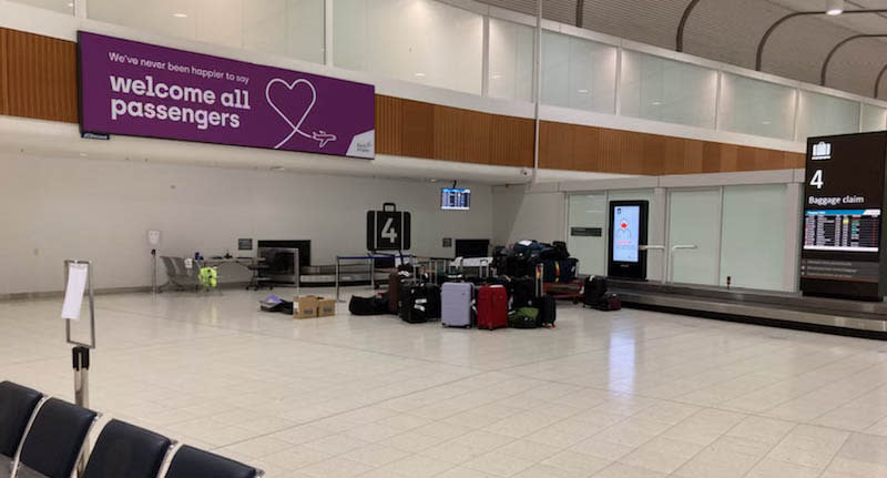 The Qantas terminal with a small pile of luggage.