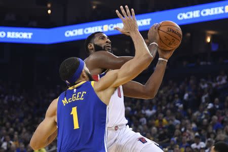 October 29, 2017; Oakland, CA, USA; Detroit Pistons center Andre Drummond (0) shoots the basketball against Golden State Warriors center JaVale McGee (1) during the first quarter at Oracle Arena. Kyle Terada-USA TODAY Sports