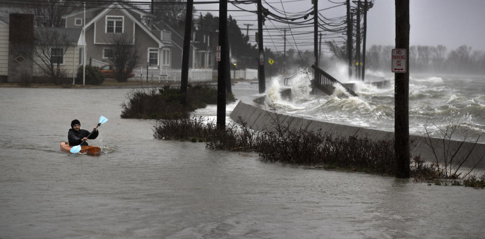 <p>Daniel Cunningham 22, of Quincy dodges waves in his kayak on a flooded E. Squantum Street in the Squantum section of Quincy, Mass., during a nor’easter storm on March 2, 2018. (Photo: Stan Grossfeld/The Boston Globe via Getty Images) </p>