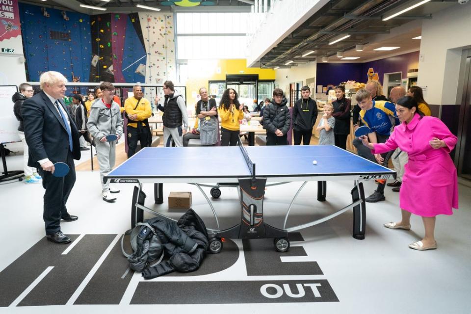 Prime Minister Boris Johnson plays table tennis with Home Secretary Priti Patel during their visit (Stefan Rousseau/PA) (PA Wire)