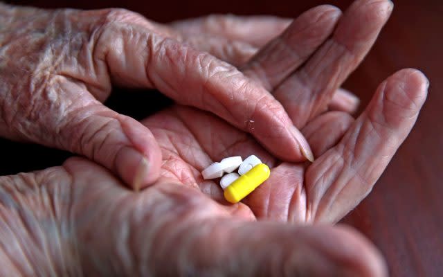 File photo dated 03/09/15 of a pensioner with her daily prescription drugs. Almost all men over 60 and women over 75 are eligible for statins, according to a new analysis.