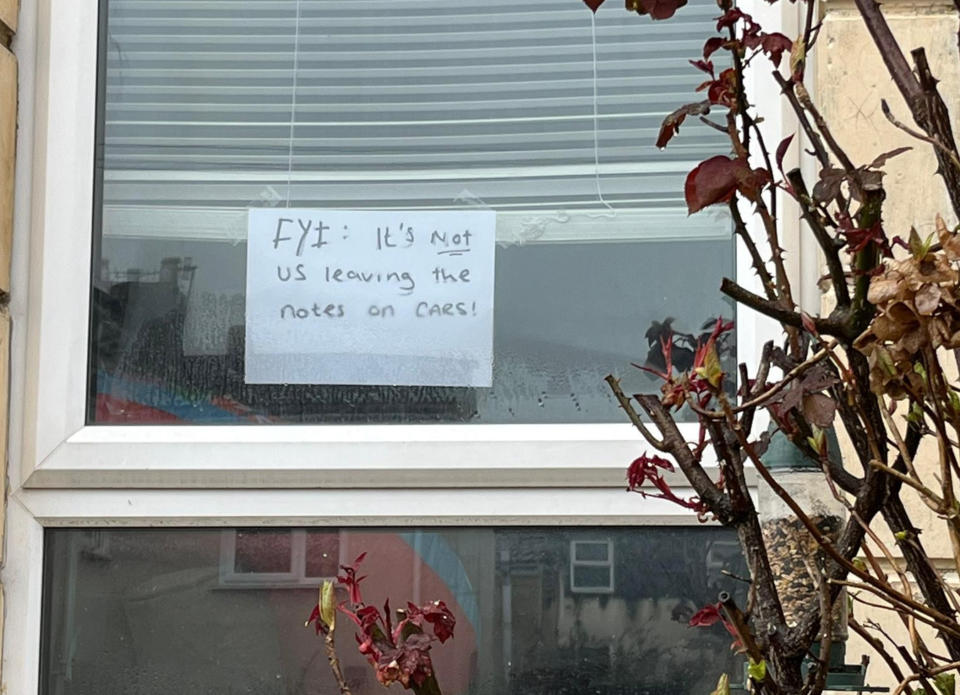 Residents have taken to posting notes in their windows to deny being behind the messages left on cars. (Reach)