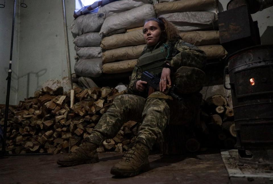 Ukrainian serviceman Anastasia (21) rests in a shelter on a front line near the Russian border (EPA)