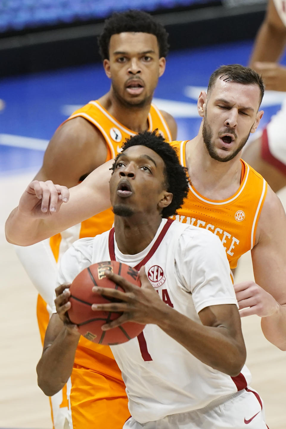 Alabama's Herbert Jones (1) drives past Tennessee defenders in the first half of an NCAA college basketball game in the Southeastern Conference Tournament Saturday, March 13, 2021, in Nashville, Tenn. (AP Photo/Mark Humphrey)