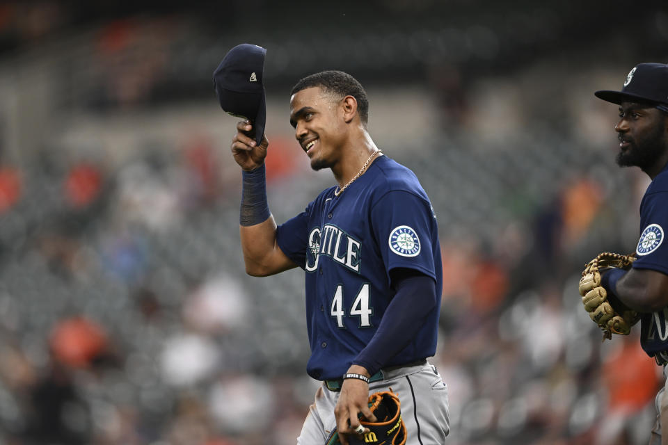 Seattle Mariners' Julio Rodriguez smiles as he takes the field after the Mariners score four runs against the Baltimore Orioles in the third inning of a baseball game Tuesday, May 31, 2022, in Baltimore. (AP Photo/Gail Burton)