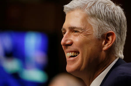 FILE PHOTO: U.S. Supreme Court nominee judge Neil Gorsuch smiles in reaction to a question as he testifies during the third day of his Senate Judiciary Committee confirmation hearing on Capitol Hill in Washington, U.S. on March 22, 2017. REUTERS/Jim Bourg/File Photo
