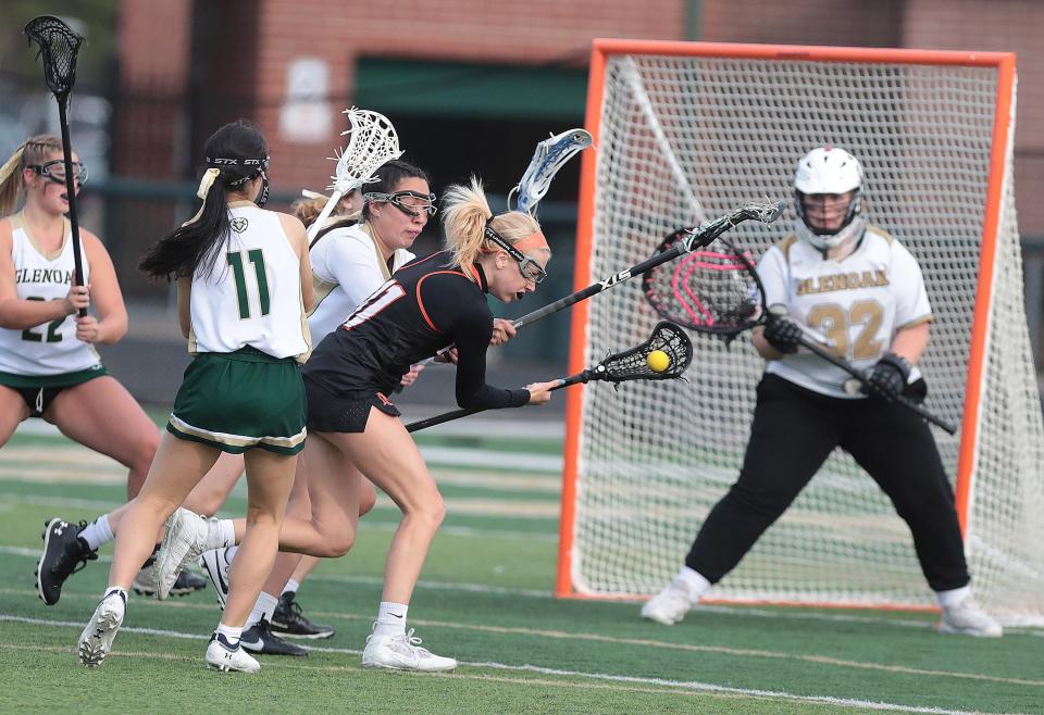Hoover's Mya Miller fights through a GlenOak defense to score a goal in the first half at GlenOak Thursday, April 28, 2022.