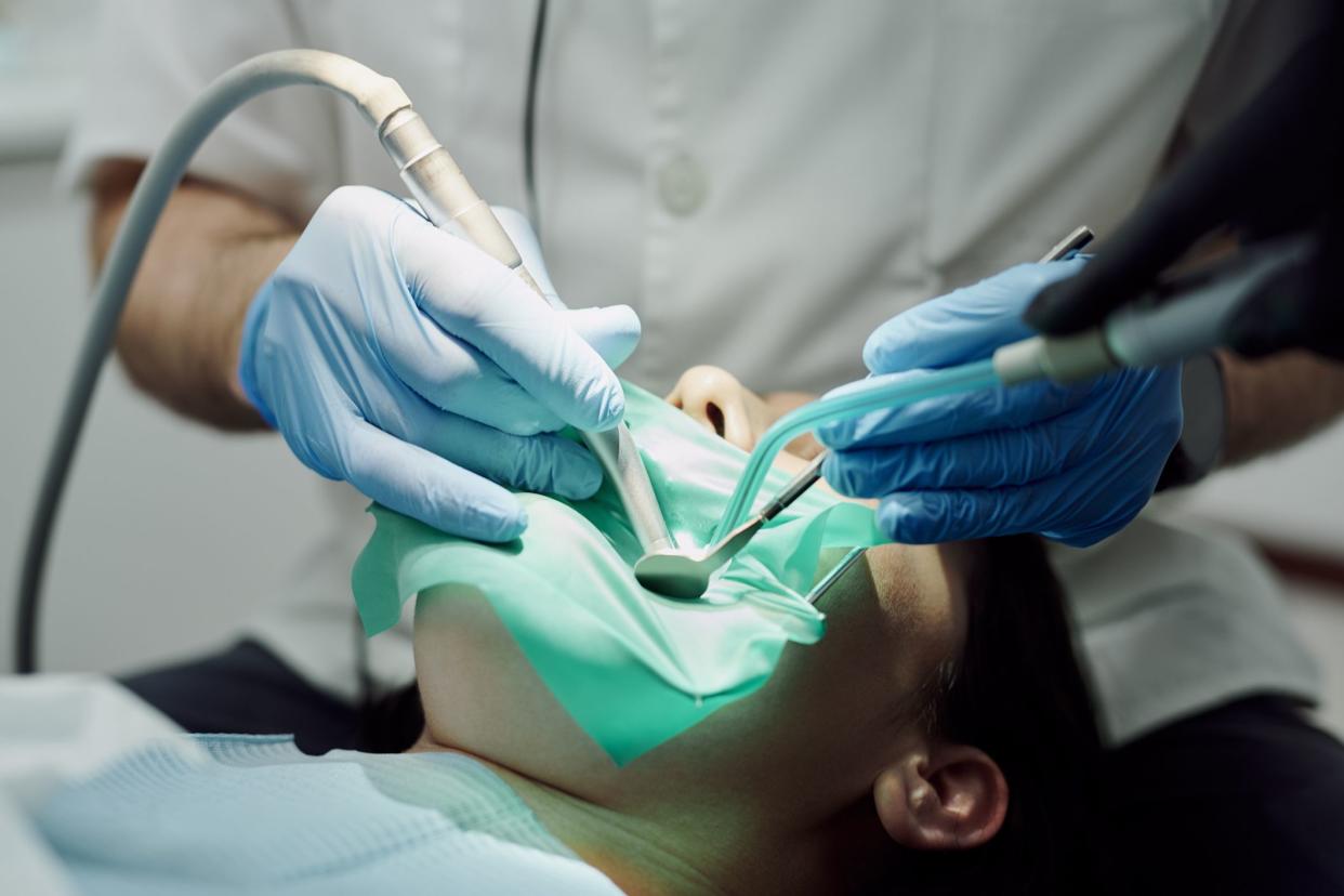 Shot of a young woman having dental work done on her teeth