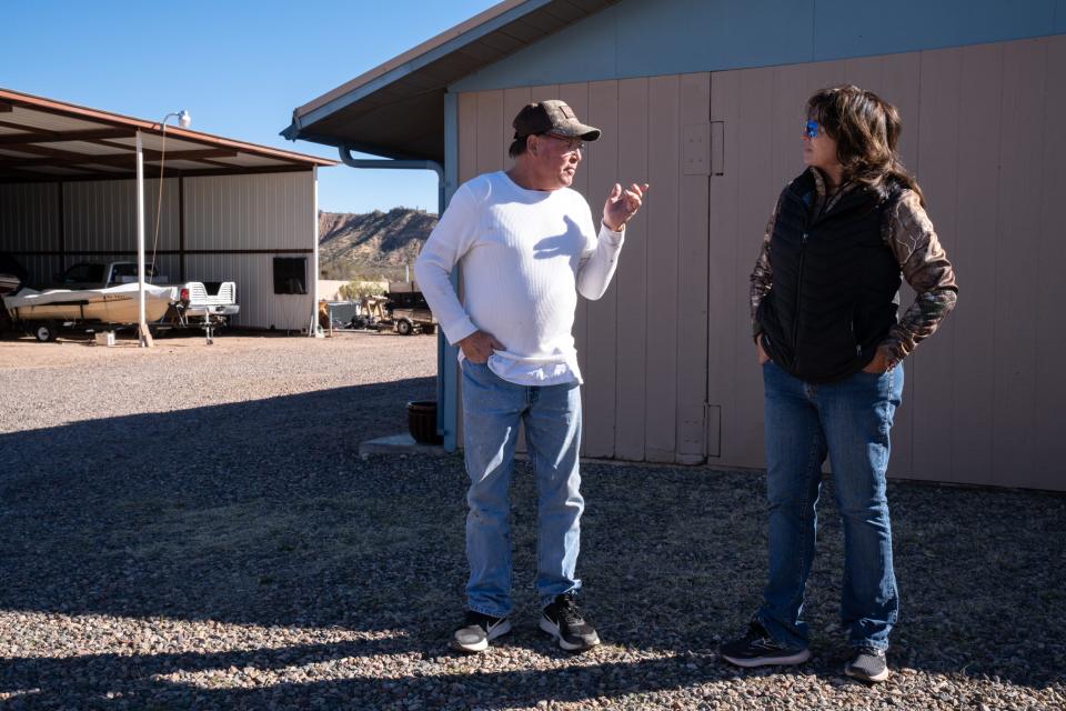 John Spencer talks with Ginger Somers on Feb. 4, 2022, outside his home in Roosevelt. Spencer has lived in Roosevelt for 49 years.