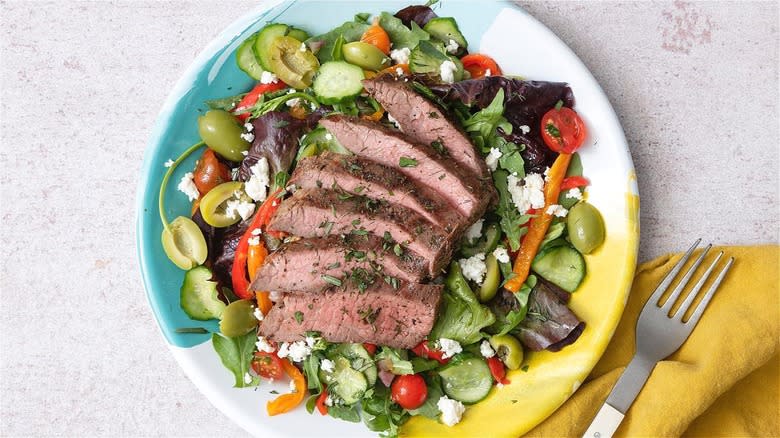 Greek salad with sliced steak