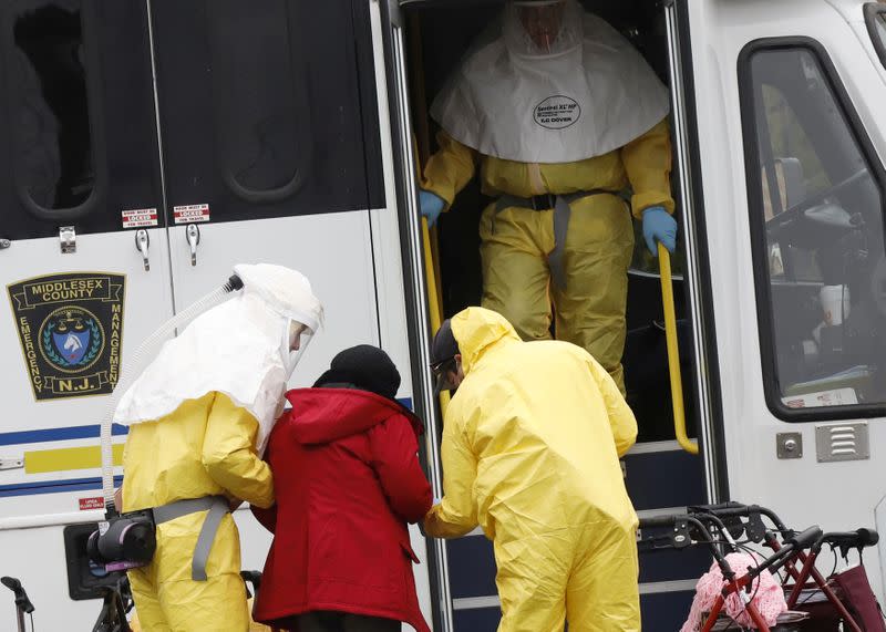 FILE PHOTO: Medical officials aid a residents from St. Joseph's nursing home to board a bus, after a number of residents tested positive for coronavirus disease (COVID-19) in Woodbridge, New Jersey