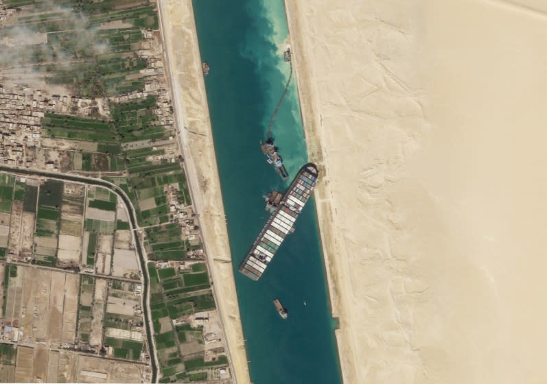 FILE - In this March 28, 2021, satellite file image from Planet Labs Inc, the cargo ship MV Ever Given sits stuck in the Suez Canal near Suez, Egypt. Consumers may face shortages and higher prices for electronics, toys, furniture and other goods should attempts to free the mammoth container ship stuck in Egypt's Suez Canal drag on several weeks. (Planet Labs Inc. via AP)