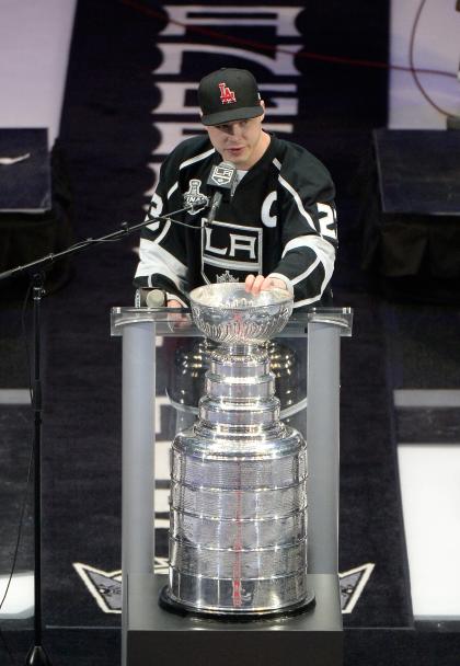 LOS ANGELES, CA - JUNE 16: Dustin Brown #23 of the Los Angeles Kings addresses the crowd during the Los Angeles Kings Victory Parade And Rally on June 16, 2014 in Los Angeles, California. (Photo by Harry How/Getty Images)