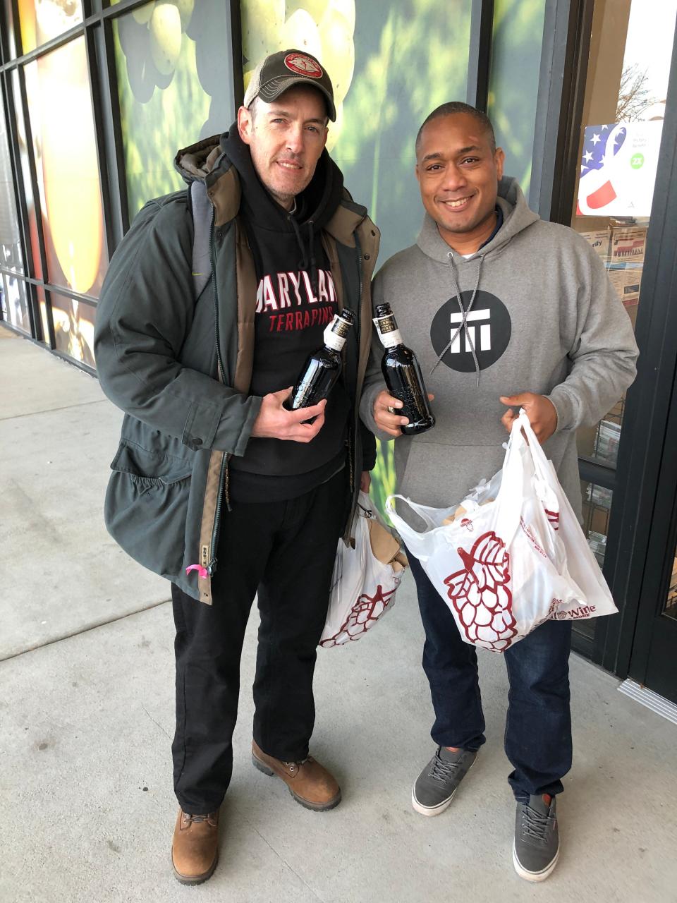 Lee Lessick, Philadelphia, 46, at left, and Lee Wood of Lawton, Oklahoma, 37, show off their purchases of Goose Island Beer Co. Bourbon County Stout at the Total Wine & More store in McLean, Va. on Black Friday, Nov. 29, 2019.