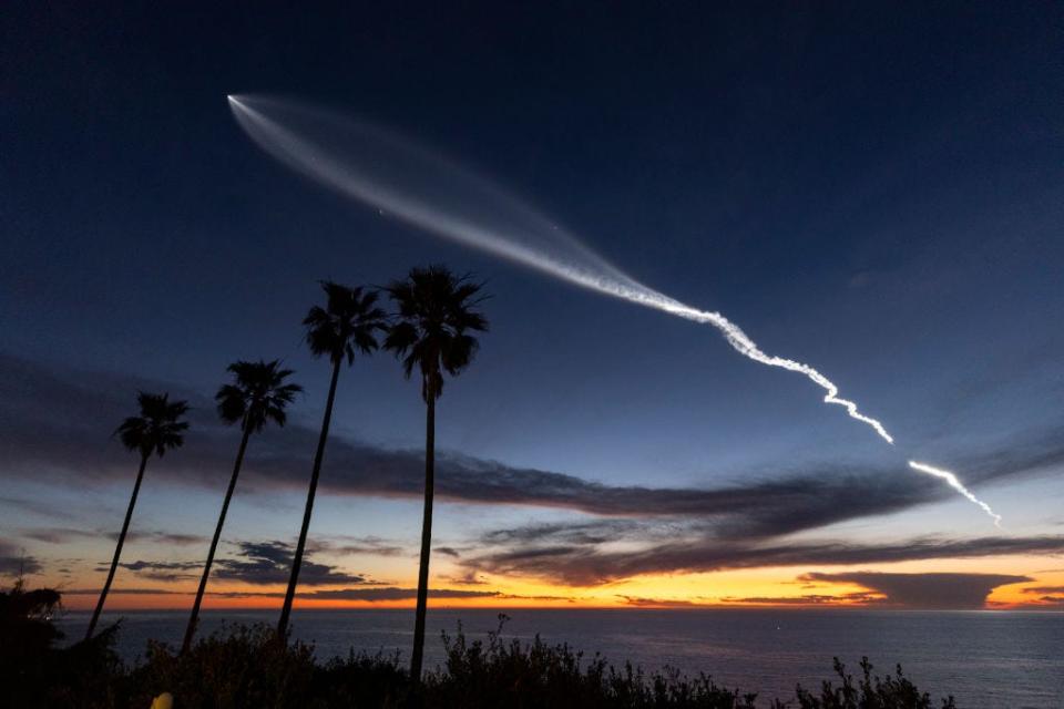 A white blob streaks the sky as a SpaceX rocket flies