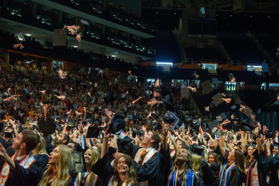 Graduates throw their caps in the air at the University of Tennessee at Knoxville spring graduation ceremony on May 20 at Thompson-Boling Arena. Many graduates are waiting to hear if the federal government will forgive some part of student loan debt. Borrowers in the state of Tennessee owe more than $31.4 billion.