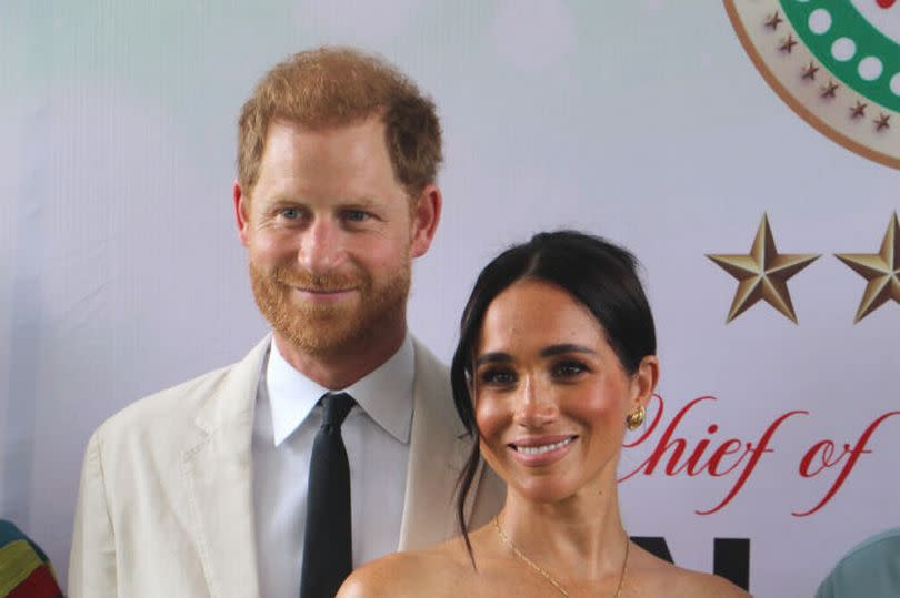 Prince Harry and Meghan pose for a photo as they attend the program held in the Armed Forces Complex in Abuja, Nigeria on May 11 -Credit:Anadolu via Getty Images