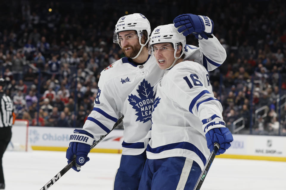 Toronto Maple Leafs' Mitchell Marner, right, celebrates his goal against the Columbus Blue Jackets with TJ Brodie during the first period of an NHL hockey game Friday, Dec. 29, 2023, in Columbus, Ohio. (AP Photo/Jay LaPrete)