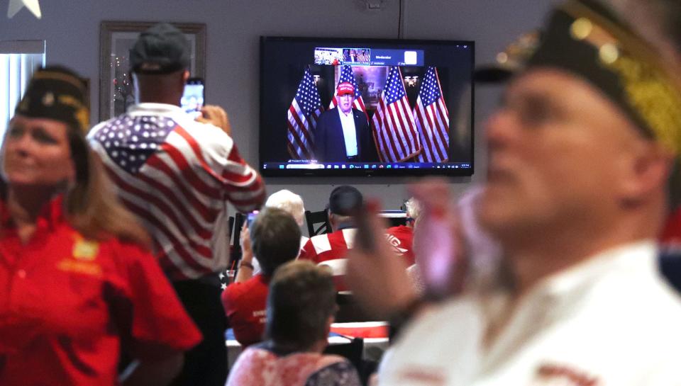 Members of Port Orange VFW Post 3282 watch former President Donald Trump on several different screens as he wishes the members of the post a happy Independence Day, Thursday July 4, 2024 during a Zoom call.