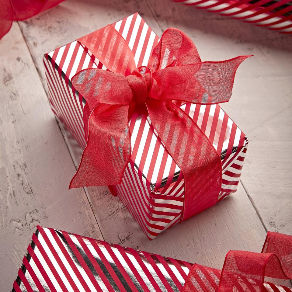 Wrapped present using red ribbon and candy striped wrapping