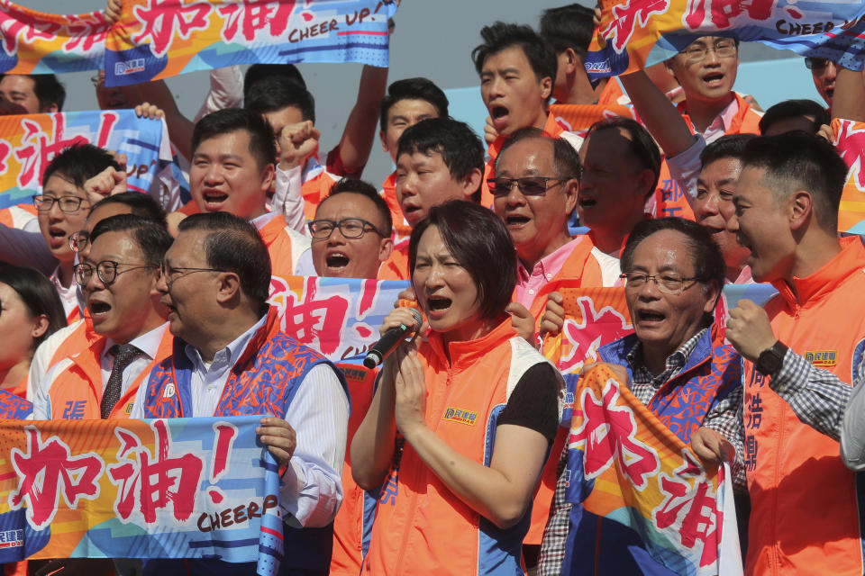 Starry Lee Wai-king, center, chairperson of pro-Beijing party Democratic Alliance for Betterment of Hong Kong (DAB) and their supporters attend an election campaign for the upcoming district council elections in Hong Kong, Thursday, Nov. 21, 2019. The 2019 Hong Kong District Council elections are scheduled for Nov. 24. (AP Photo/Kin Cheung)