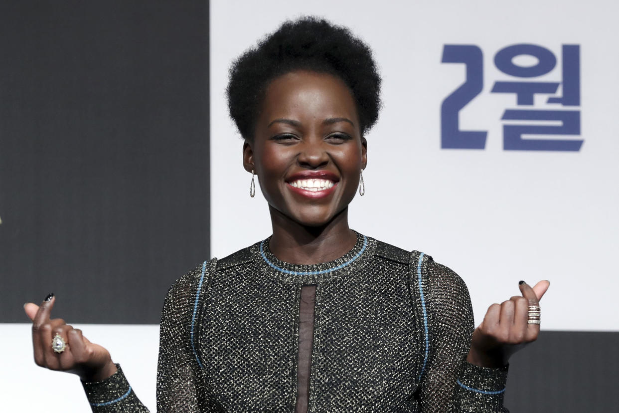Lupita Nyong'o pulls a double finger heart at the Seoul premiere of "Black Panther" earlier this month.