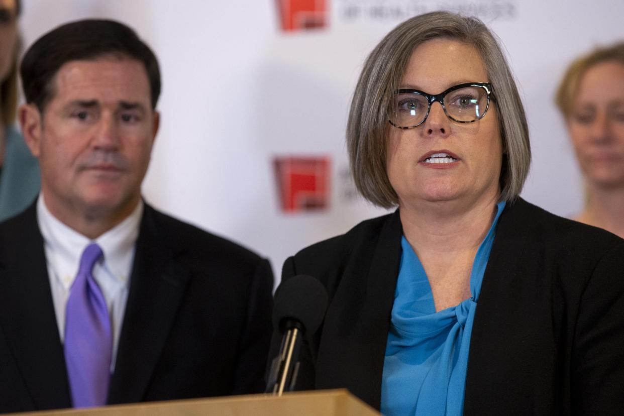 A Republican group headed by Gov. Doug Ducey (right) is criticizing Democratic gubernatorial candidate Katie Hobbs for flipping her stance on Title 42.