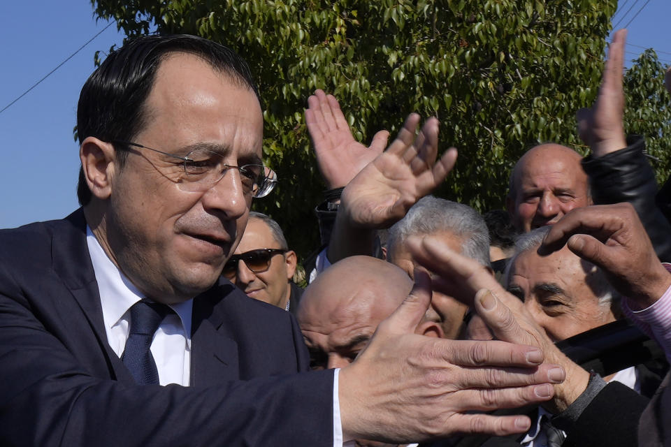 Presidential candidate Nikos Christodoulides greets his supporters after casting his vote during the presidential elections in Geroskipou in south west coastal city of Paphos, Cyprus, Sunday, Feb. 12, 2023. Voting has started in a runoff to elect ethnically split Cyprus' eighth new president, pitting a former foreign minister who campaigned as a unifier eschewing ideological and party divisions against a popular veteran diplomat. Some 561,000 citizens are eligible to vote and both Nikos Christoulides, the ex-foreign minister and Andreas Mavroyiannis are hoping for a higher turnout than the 72% that cast ballots in Feb. 5 first round. (AP Photo/Petros Karadjias)