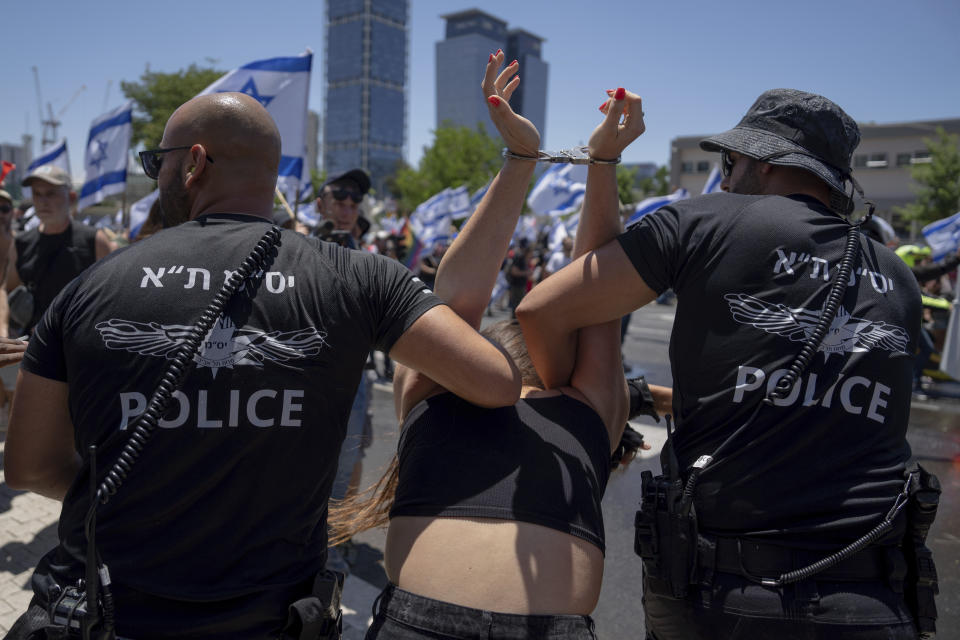 Israeli police detain a demonstrator during a protest against plans by Prime Minister Benjamin Netanyahu's new government to overhaul the judicial system, in Tel Aviv, Israel, Tuesday, July 11, 2023. (AP Photo/Oded Balilty)