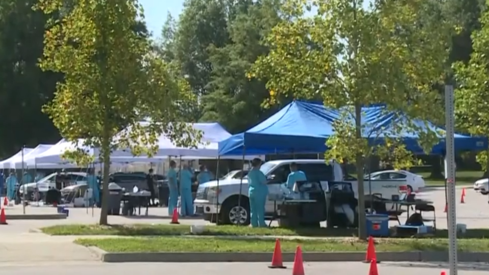 Cars line up at a mobile testing center. / Credit: CBS News