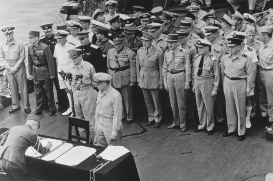 FILE - General of the Army Douglas MacArthur, Supreme Allied Commander, and General Wainwright, who surrendered to the Japanese after Bataan and Corregidor, witness the formal Japanese surrender signatures aboard the USS Missouri in Tokyo Bay on Sept. 2, 1945. Several dozen aging U.S. veterans, including some who were in Tokyo Bay as swarms of warplanes buzzed overhead and nations converged to end World War II, will gather on the battleship in Pearl Harbor in September to mark the 75th anniversary of Japan's surrender. (AP Photo, File)