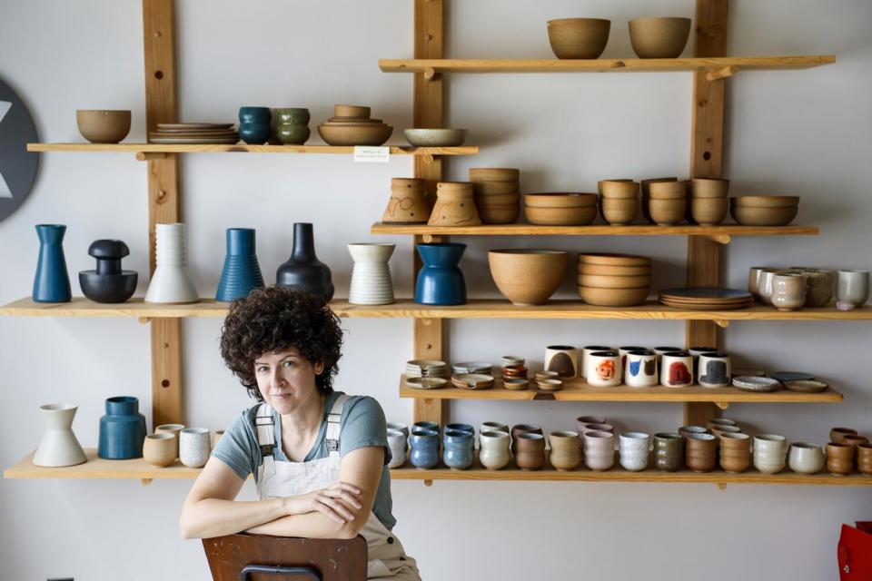 Potter Becki Chernoff of bX Ceramics is surrounded by samples of her work at her studio.