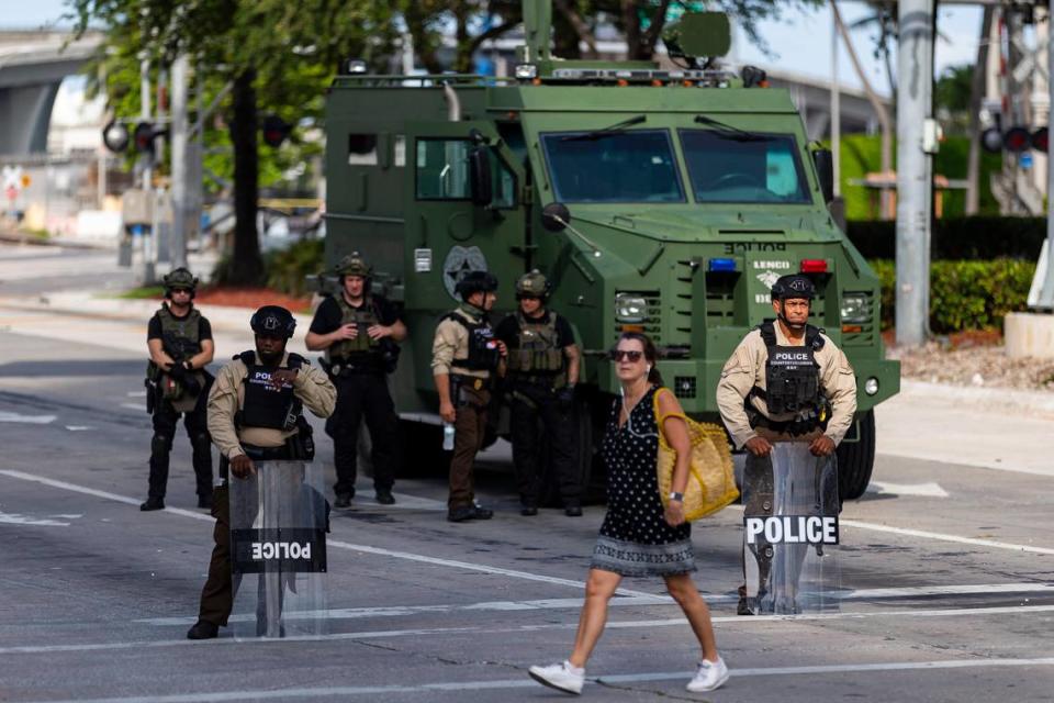 Police officers keep guard as activists gather near the Freedom Tower during a Justice for George Floyd protest in downtown Miami on Monday, June 1, 2020.
