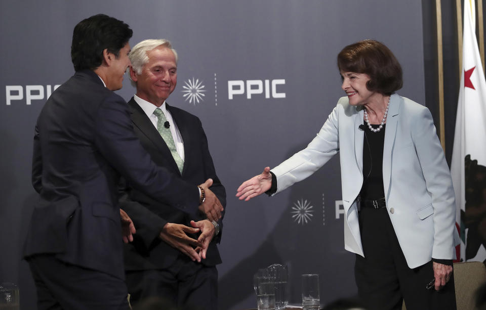 California Sen. Dianne Feinstein, D-Calif., right, reaches to shake the hand of California Sen. Kevin de Leon, D-Los Angeles, after a debate on Wednesday, Oct. 17, 2018, in San Francisco. Feinstein shared the stage with an opponent for the first time since 2000 when she debated state Sen. Kevin de Leon. The two Democrats are facing off in the Nov. 6 election. Public Policy Institute of California CEO and debate monitor Mark Baldassare is seen at center. (AP Photo/Ben Margot)