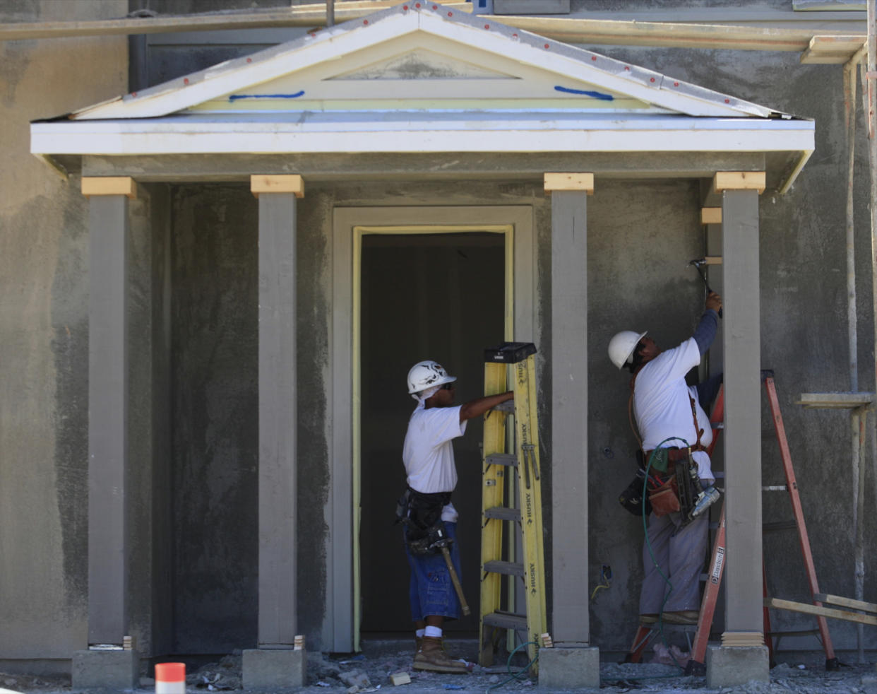 Workers build the main entrance to a new home by Lennar in Santa Clarita, Calif. (Damian Dovarganes, AP Photo)