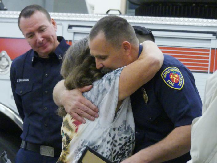 Jean Henson hugs an Apple Valley Fire Protection District paramedic who helped save her husband, Randy&#x002019;s, life after he fell off a ladder.