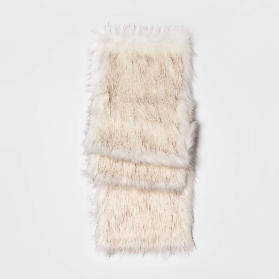 This photo shows the Threshold faux fur table runner. From tablescapes to apparel, the gift possibilities in white are endless for the holidays. (AP Photo/Target).