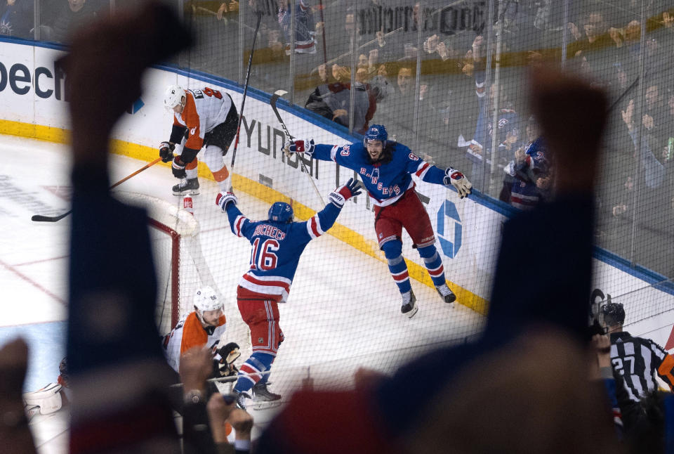 New York Rangers' Vincent Trocheck (16) and Mika Zibanejad celebrate Trocheck's goal against the Philadelphia Flyers during the third period of an NHL hockey game TTuesday, March 26, 2024 in New York. (AP Photo/Peter K. Afriyie)