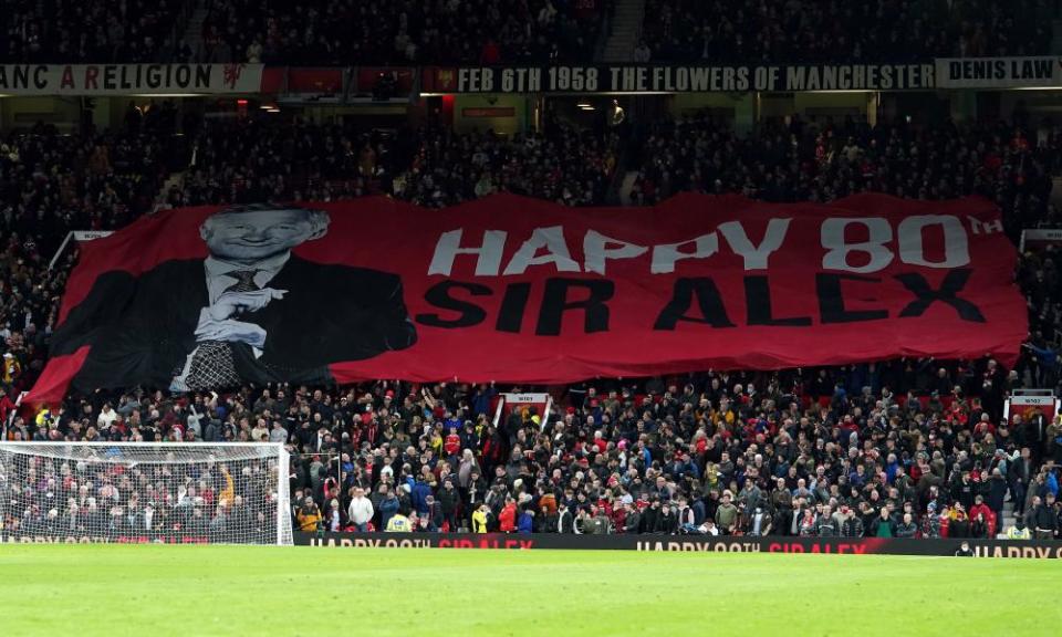 A banner celebrating Sir Alex Ferguson’s 80th birthday is unfurled at the Stretford End