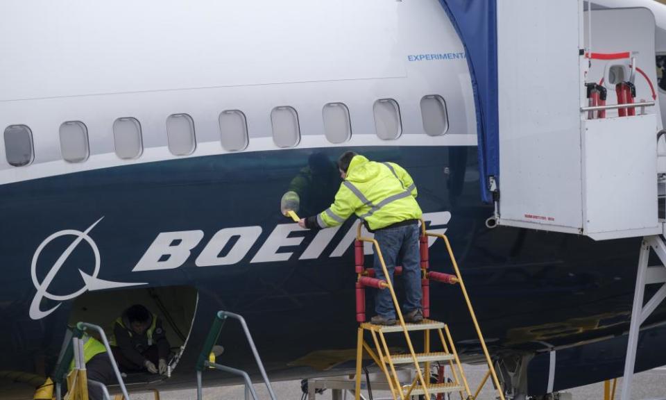 Boeing employees work on a 737 Max aircraft at the company’s factory in Renton, Washington.